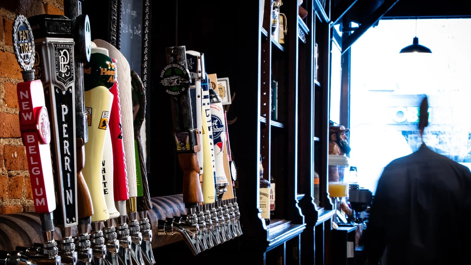 A row of beer tap handles at the Copper Athletic Club, including Michigan breweries